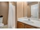 This bathroom has a tile shower, framed vanity with a countertop, and neutral colored walls at 232 Christian Cir, Carrollton, GA 30116