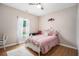 Cozy bedroom with a ceiling fan, window with sheer curtains, and ornate metal bed frame at 232 Christian Cir, Carrollton, GA 30116