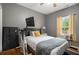 Comfortable bedroom features a window, ceiling fan, and TV at 232 Christian Cir, Carrollton, GA 30116
