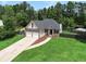 Charming two-story home boasts a brick and siding exterior, attached two-car garage, and a well-manicured front lawn at 232 Christian Cir, Carrollton, GA 30116
