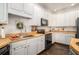 Well-lit kitchen boasts white cabinets, wood countertops, and modern appliances at 232 Christian Cir, Carrollton, GA 30116