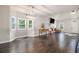Bright and spacious living room features a vaulted ceiling, dark hardwood floors, and a decorative fireplace at 232 Christian Cir, Carrollton, GA 30116