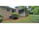 Brick home exterior with a screened porch, complemented by a well-maintained lawn and landscaping at 2600 Amberly Dr, Dunwoody, GA 30360
