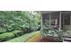 View of backyard featuring green shrubbery, backyard, patio and surrounding trees at 2600 Amberly Dr, Dunwoody, GA 30360