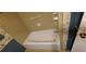 Bathroom featuring a white tub, tiled walls, and a charming, classic design at 2600 Amberly Dr, Dunwoody, GA 30360