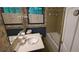 Bathroom with vanity, sink, and a tub/shower combo, featuring classic wallpaper and fixtures at 2600 Amberly Dr, Dunwoody, GA 30360