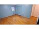 Spacious bedroom with hardwood floors, light blue walls, and a large closet for ample storage at 2600 Amberly Dr, Dunwoody, GA 30360