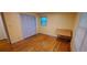 Bright bedroom with hardwood floors, light yellow walls, and a spacious closet at 2600 Amberly Dr, Dunwoody, GA 30360