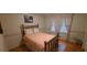 Cozy bedroom with hardwood floors, a brass bed frame, and charming floral accents at 2600 Amberly Dr, Dunwoody, GA 30360