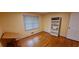 Bedroom with hardwood floors, a bookshelf, and a sunny window, perfect for relaxation at 2600 Amberly Dr, Dunwoody, GA 30360