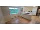 Bright kitchen with hardwood floors, cream-colored cabinets, and a view to backyard at 2600 Amberly Dr, Dunwoody, GA 30360