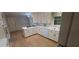Well-lit kitchen with white cabinetry, modern appliances, and hardwood floors at 2600 Amberly Dr, Dunwoody, GA 30360