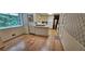 Traditional kitchen with hardwood floors, white cabinets, and appliances, adjacent to breakfast nook at 2600 Amberly Dr, Dunwoody, GA 30360