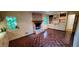 Cozy living room featuring a brick fireplace, built-in shelves, and unique parquet flooring at 2600 Amberly Dr, Dunwoody, GA 30360