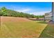 Spacious backyard features a large lawn and wooded perimeter, perfect for outdoor activities and privacy at 2953 Balvenie Pl, Acworth, GA 30101