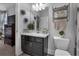 Well-lit bathroom features sleek fixtures, modern vanity, decorative wall art, and organized shelving at 2953 Balvenie Pl, Acworth, GA 30101