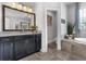 Well-lit bathroom featuring a tub, shower, and granite countertops on dark cabinetry, with backyard views at 2953 Balvenie Pl, Acworth, GA 30101