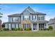 Charming two-story home featuring blue siding, stone accents, a welcoming front porch, and lush green lawn at 2953 Balvenie Pl, Acworth, GA 30101