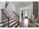 Inviting foyer with staircase, hardwood floors, and elegant decor welcomes you home at 2953 Balvenie Pl, Acworth, GA 30101