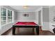 Game room features a striking red pool table, hardwood floors, and bright natural light at 2953 Balvenie Pl, Acworth, GA 30101