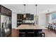 Modern kitchen with stainless steel appliances, large island, and dark wood cabinetry at 2953 Balvenie Pl, Acworth, GA 30101