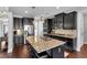Modern kitchen features dark cabinetry, granite counters, stainless appliances, and an island at 2953 Balvenie Pl, Acworth, GA 30101