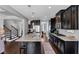 Large kitchen island with seating, dark cabinets, and hardwood floors perfect for cooking at 2953 Balvenie Pl, Acworth, GA 30101