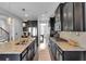 Modern kitchen with granite countertops, dark cabinetry, and stainless steel appliances at 2953 Balvenie Pl, Acworth, GA 30101