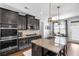 Modern kitchen boasts stainless steel appliances, granite countertops and kitchen island with bar stool seating at 2953 Balvenie Pl, Acworth, GA 30101