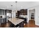 Open kitchen with granite island, stainless steel appliances, and stylish pendant lighting at 2953 Balvenie Pl, Acworth, GA 30101