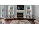 Living room featuring a fireplace with stone surround, flanked by windows and tables at 2953 Balvenie Pl, Acworth, GA 30101