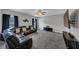 Spacious living room featuring a comfortable leather sectional, ceiling fan and large TV at 2953 Balvenie Pl, Acworth, GA 30101