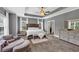 Bright main bedroom featuring a tray ceiling, large windows, carpet flooring and sitting area at 2953 Balvenie Pl, Acworth, GA 30101