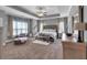 Spacious main bedroom with tray ceilings, a ceiling fan, sitting area, and serene, neutral decor at 2953 Balvenie Pl, Acworth, GA 30101