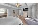 Relaxing main bedroom with tray ceilings, ceiling fan, and sitting area with views into ensuite bath at 2953 Balvenie Pl, Acworth, GA 30101