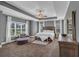 Bright main bedroom featuring a tray ceiling, large windows, carpet flooring and sitting area at 2953 Balvenie Pl, Acworth, GA 30101