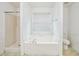 Clean bathroom features a white tub and shower combination with a window for natural light at 433 Pearl St, Locust Grove, GA 30248