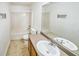 Bright bathroom featuring a shower and tub combination, toilet, and vanity with a mirror at 433 Pearl St, Locust Grove, GA 30248