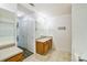 Bathroom with a wood cabinet vanity, a large mirror and neutral walls at 433 Pearl St, Locust Grove, GA 30248