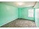 Bright bedroom featuring a neutral carpet, soft light, and a freshly painted wall at 433 Pearl St, Locust Grove, GA 30248