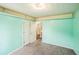 Bright bedroom with light teal walls, neutral carpet, and double-door closet offers ample storage at 433 Pearl St, Locust Grove, GA 30248