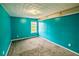 Bedroom with teal walls, neutral carpet and natural light from a window at 433 Pearl St, Locust Grove, GA 30248