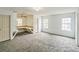 Spacious living room features neutral carpet, white walls, and built-in desk nook for flexible living at 433 Pearl St, Locust Grove, GA 30248