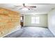 Bright living room featuring neutral walls, plush carpet, and large windows at 433 Pearl St, Locust Grove, GA 30248