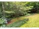 Secluded backyard featuring lush landscaping, including hydrangeas, with a seating area and mature trees at 5049 Lake Ter, Marietta, GA 30068