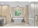 Elegant bathroom with a soaking tub, natural light, and granite vanity at 5049 Lake Ter, Marietta, GA 30068
