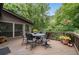 Spacious outdoor deck area with a metal table and chairs overlooking a private wooded backyard at 5049 Lake Ter, Marietta, GA 30068