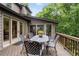 Spacious outdoor deck area with a metal table and chairs overlooking a private wooded backyard at 5049 Lake Ter, Marietta, GA 30068