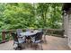 Spacious outdoor deck area with a metal table and chairs overlooking a private wooded backyard at 5049 Lake Ter, Marietta, GA 30068