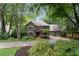 Brick home showcasing an inviting front yard with mature trees at 5049 Lake Ter, Marietta, GA 30068
